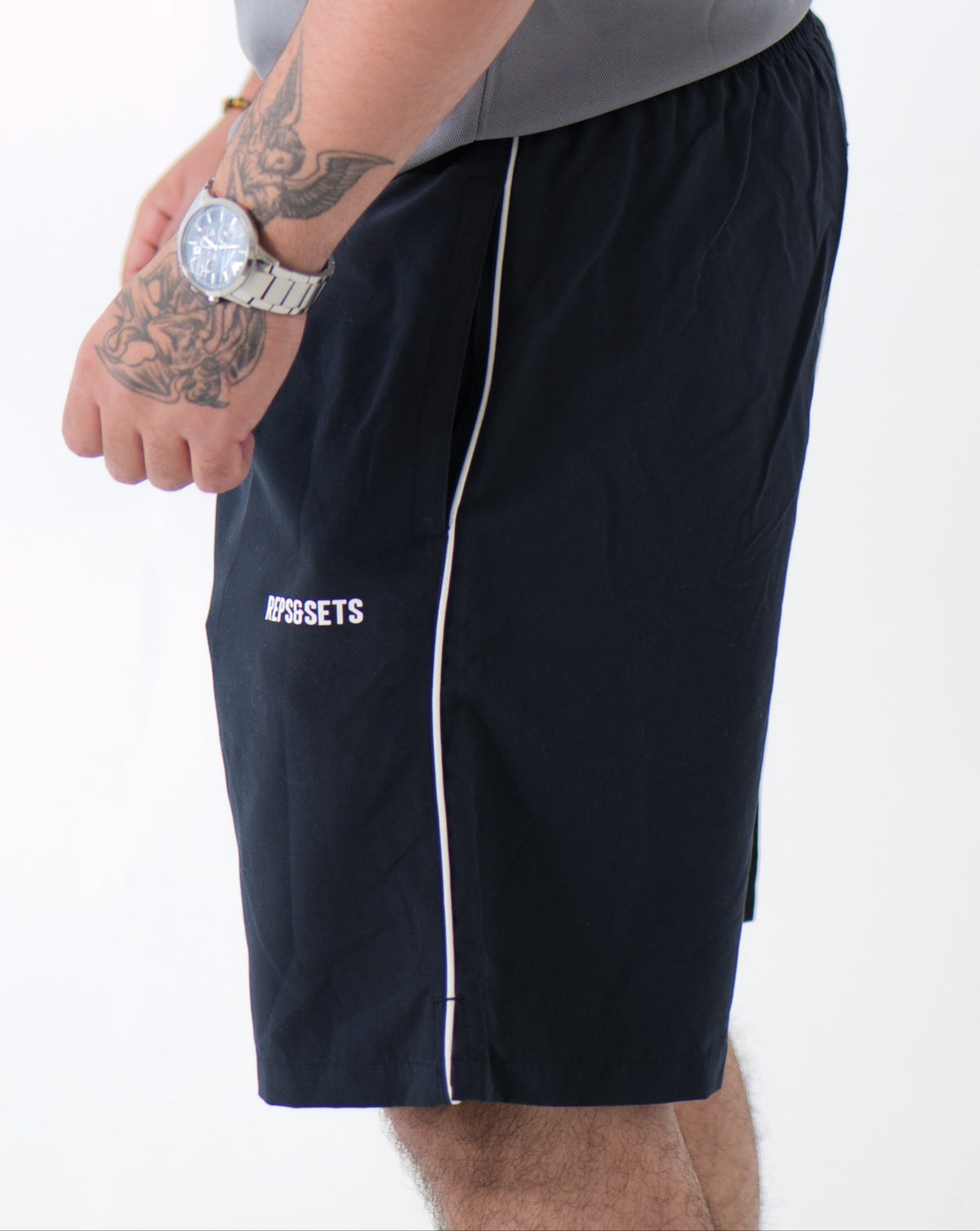 The Performance Shorts in navy blue with white side stripes, athletic fit, designed for sports, gym, and casual wear
