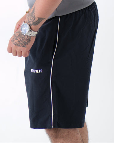 The Performance Shorts in navy blue with white side stripes, athletic fit, designed for sports, gym, and casual wear